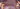 Maroon background with gold stars and gold leaves on either side of image